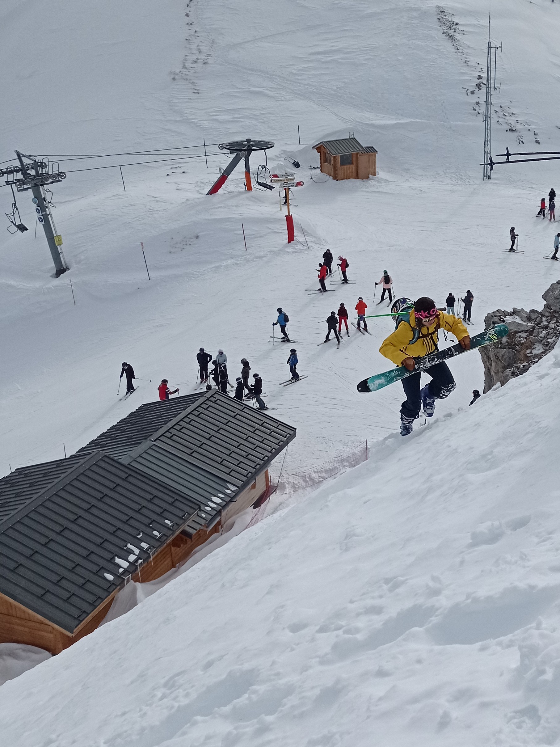 Hiking up behind the Pisteurs' hut with the Roc Merlet chairlift in the background.