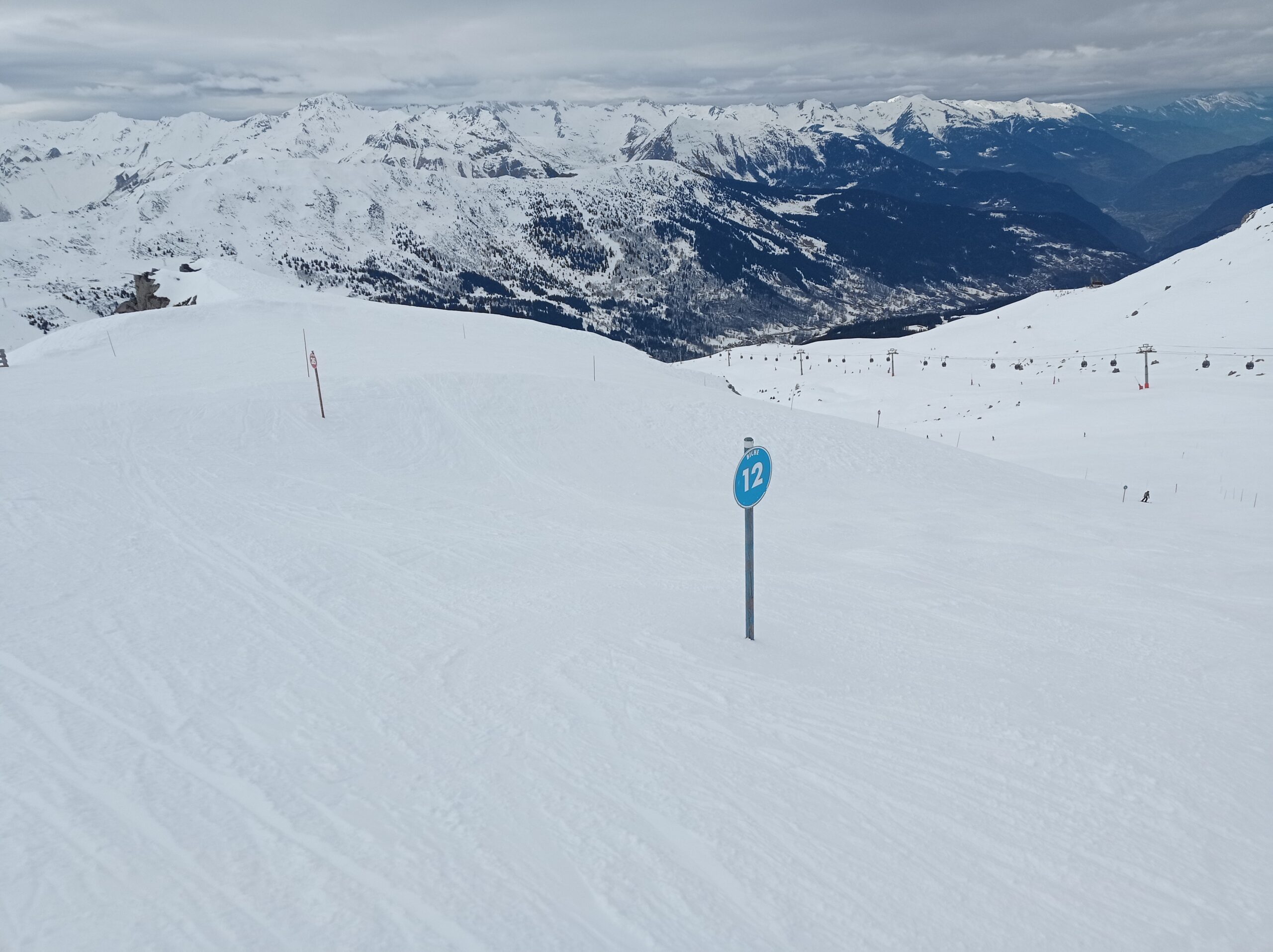 Biche piste marker 12, directly behind the piste  map signboard, marks the start of Ani's Moguls. 