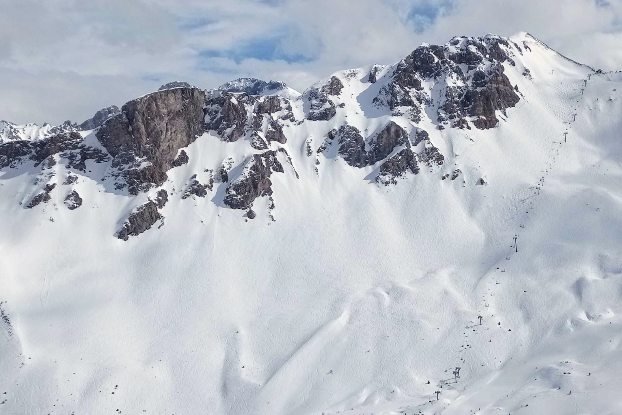 The ethereal west face of the Crete de Plan Mugnier with the earthly Chanrossa chairlift on the right of the photo.