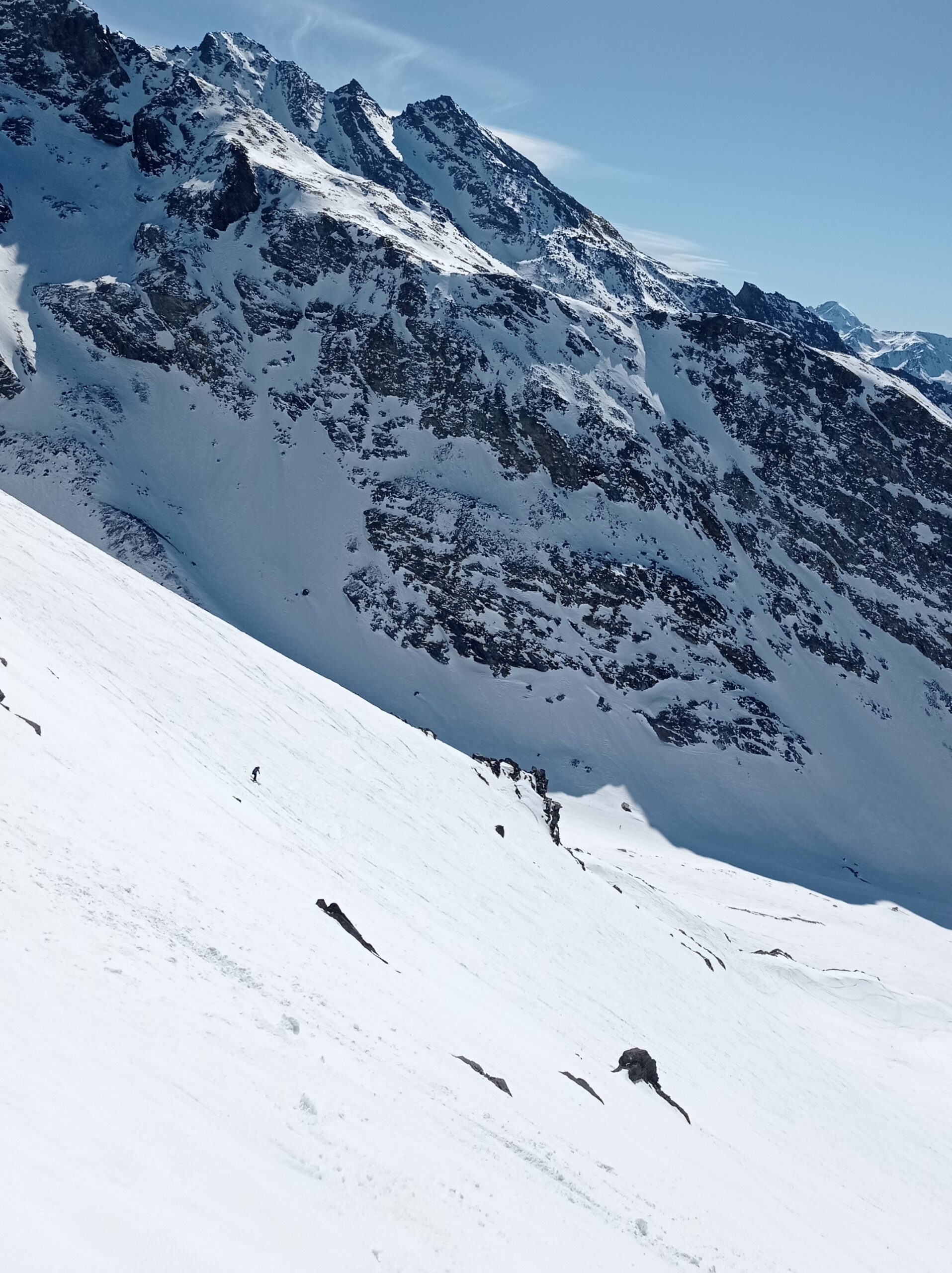 Dropping into the Col with the spectacular Le Peyron feature in the background.